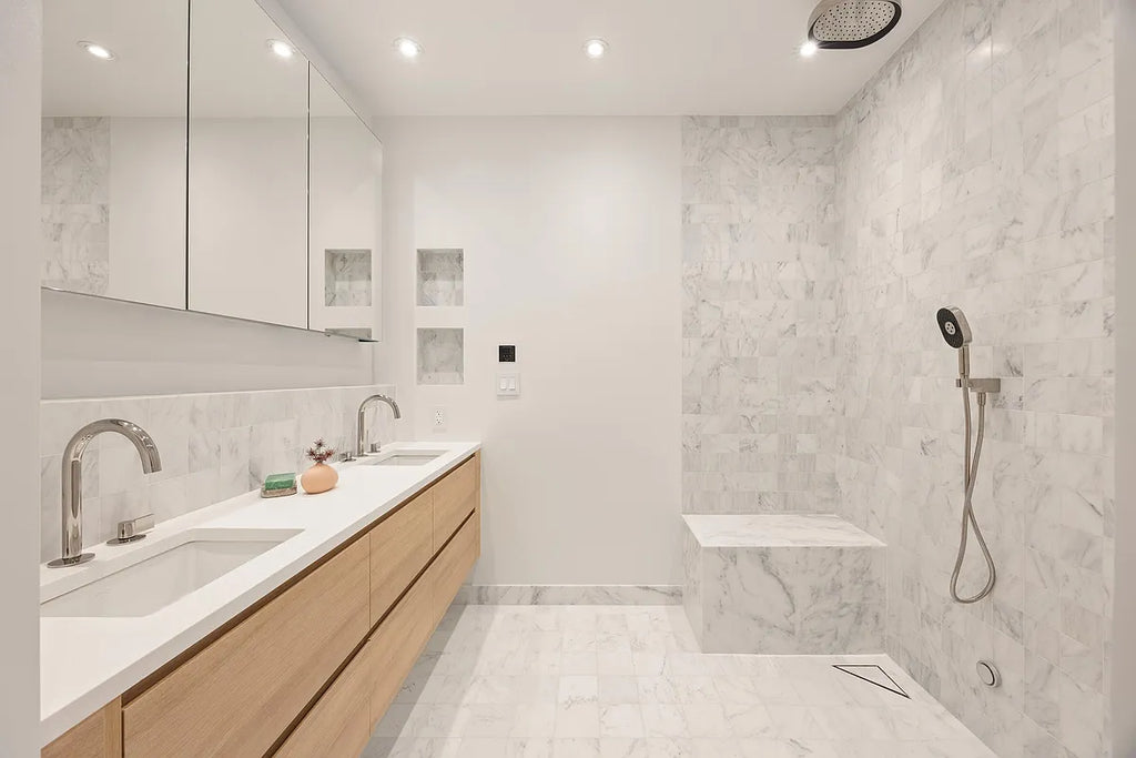 Contemporary bathroom with wood floating vanity, marble tile, built-in tub, and walk-in shower