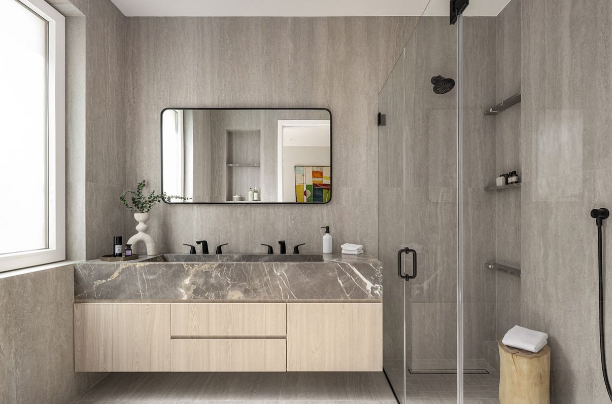 Modern bathroom with floating wood cabinets and marble vanity